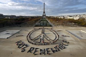 Hundreds of environmentalists arrange their bodies to form a message of hope and peace in front of the Eiffel Tower in Paris, France, December 6, 2015, as the World Climate Change Conference 2015 (COP21) continues at Le Bourget near the French capital. REUTERS/Benoit Tessier TPX IMAGES OF THE DAY - RTX1XF6V