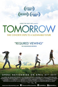 Tomorrow film poster showing four people walking on a grassy hill, the last person holding a video camera. It has the tagline: "Take Concrete Steps to A Sustainable Future" and a quote from the Hollywood Reporter saying: "Required Viewing."