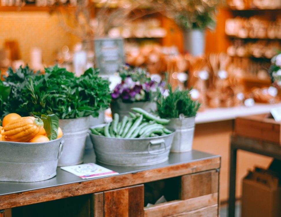Various fresh vegetables and natural products in a small shop.