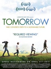 Tomorrow film poster showing four people walking on a grassy hill, the last person holding a video camera. It has the tagline: "Take Concrete Steps to A Sustainable Future" and a quote from the Hollywood Reporter saying: "Required Viewing."